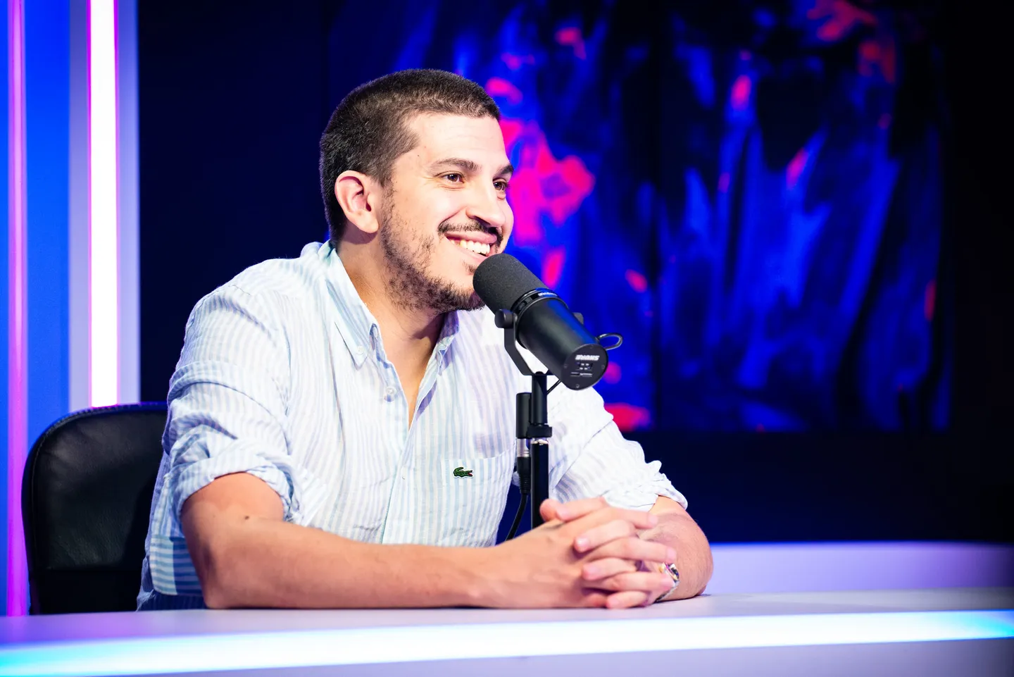 Commentateur souriant devant son microphone lors d’un événement