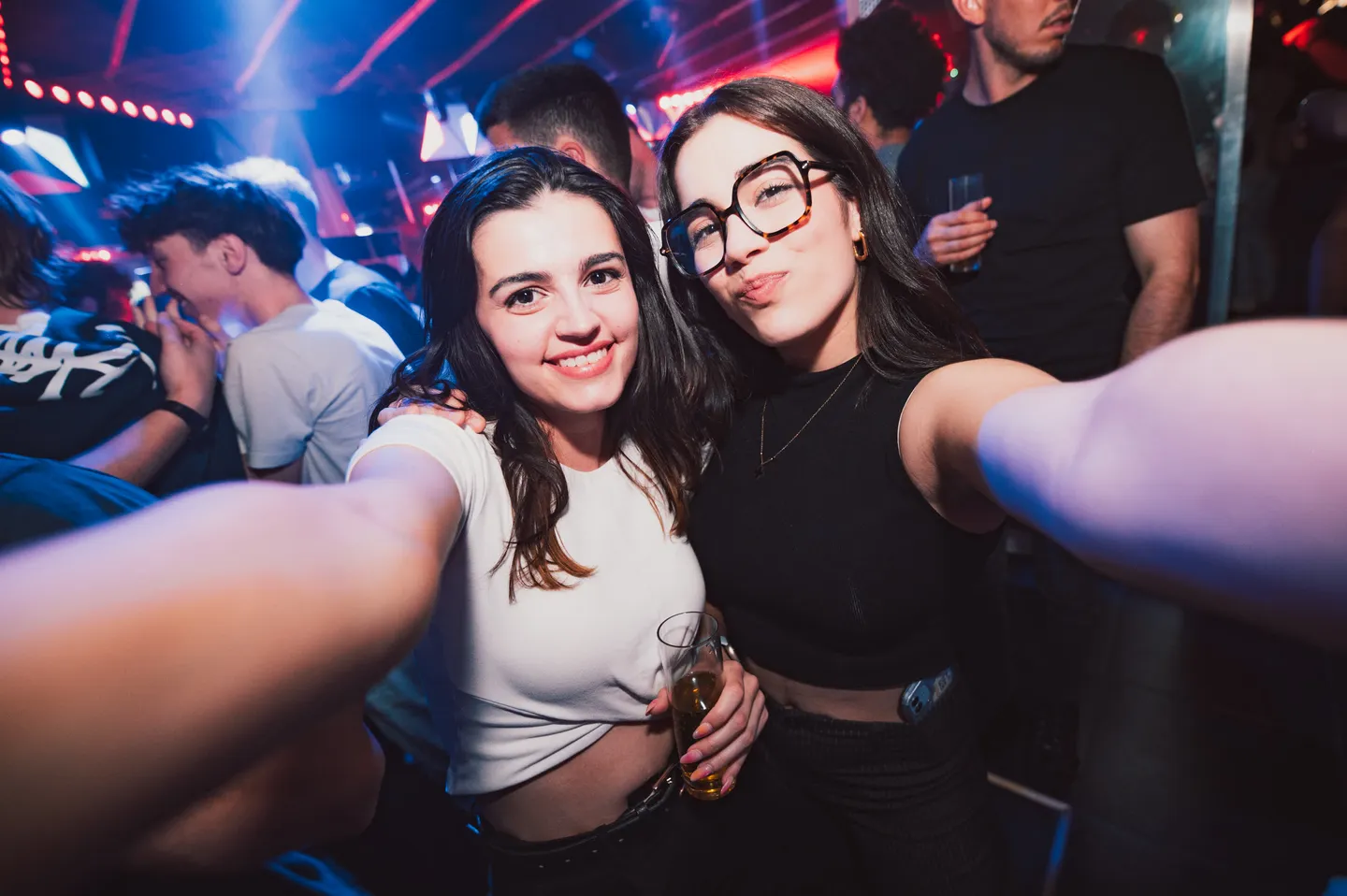 Deux participantes prennent la pose pendant une soirée en discothèque